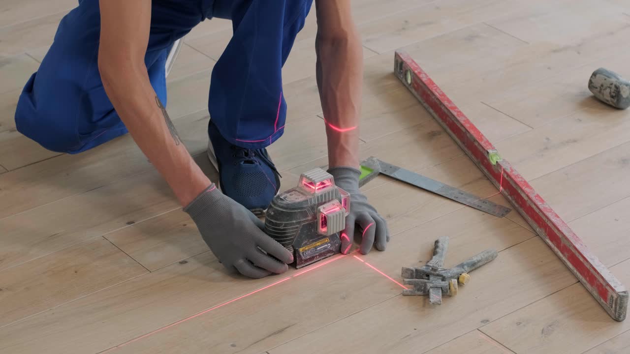 Construction, renovation, repair apartment. Installing ceramic floor tiles - measuring and cutting the pieces. Cuts tile. Tile cutting