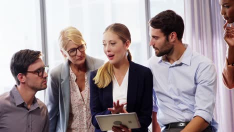 businesspeople interacting over a digital tablet