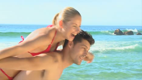 couple pretending to fly on a beach