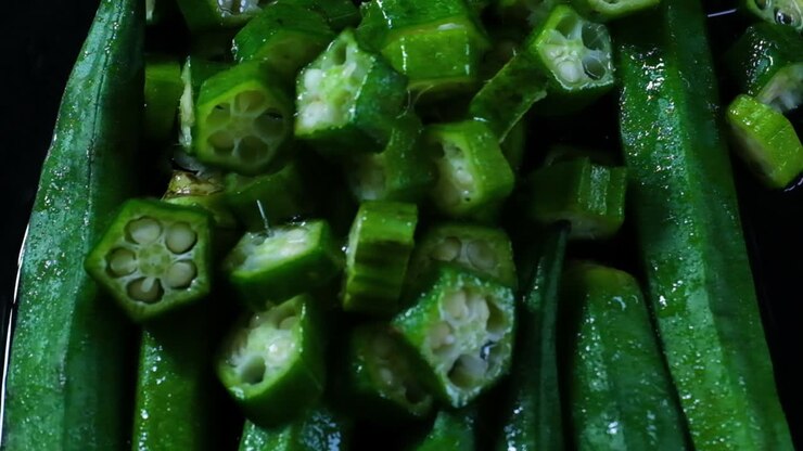 Fresh Wet Whole Okra In Water With Chopped Pieces Dropping