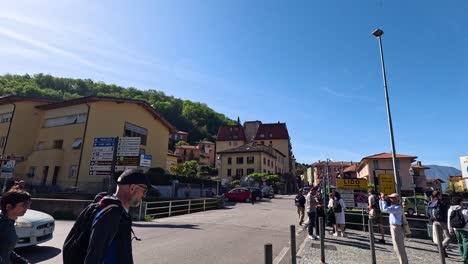 people walking and cars passing in varenna