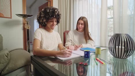 two women studying together at a table