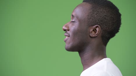 profile view of young happy african man relaxing with eyes closed