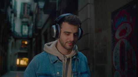 young millennial man walk on street with phone