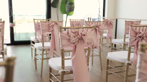 many white and gold chairs set up in rows in an empty room for small indoor wedding ceremony 1080p 60fps