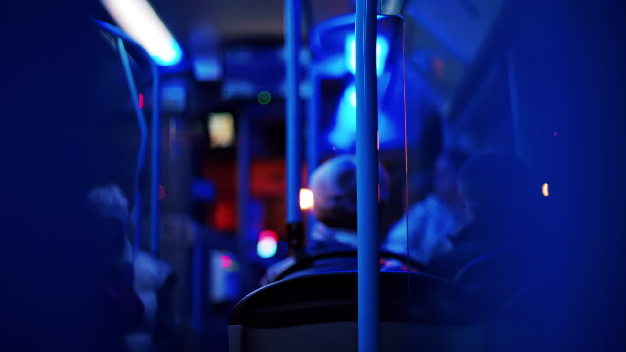 People sitting in a moving train in the evening with blue lighting