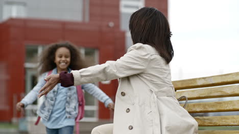 Madre-Con-Impermeable-Espera-A-Su-Hija-Fuera-De-La-Escuela