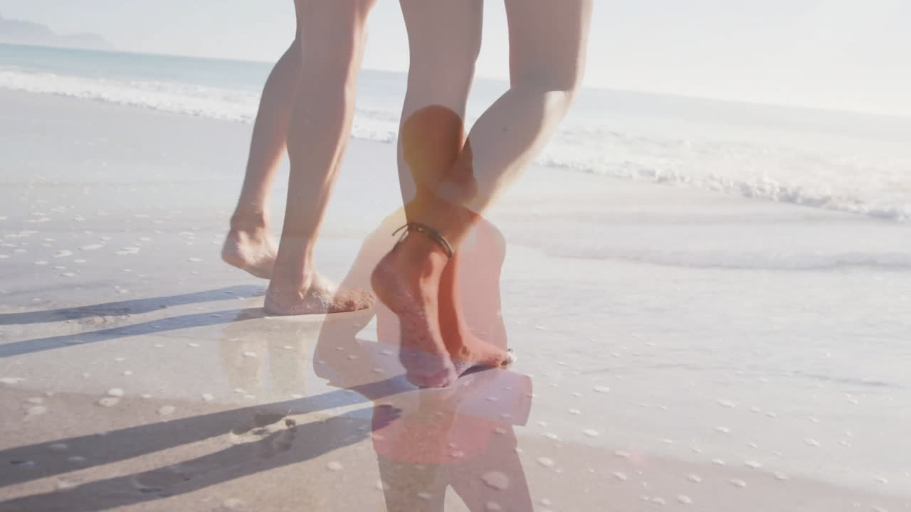 couple walking barefoot along beach for health marketing with animated wellness icons over waves