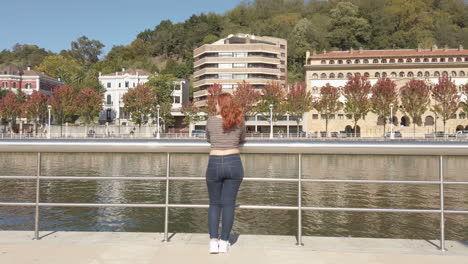 woman looking at a city river view