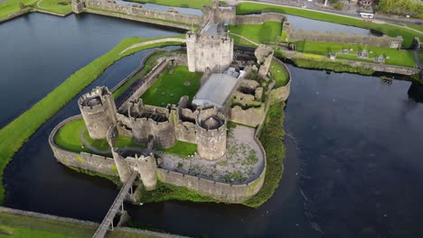 aerial circling shot of caerphilly castle in southern wales, united kingdom