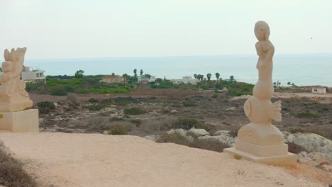 contemporary sculptures of mythical beasts and ancient gods in a landscaped park in ayia napa, cyprus. wide shot