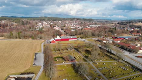 flight above bjorketorps church in ravlanda town, harryda with overview of vast landscape on a sunny day in sweden