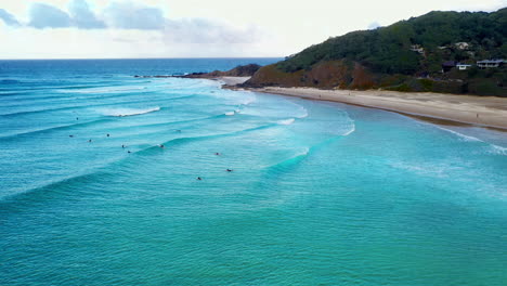 wide drone of surfers at wategos beach byron bay australia