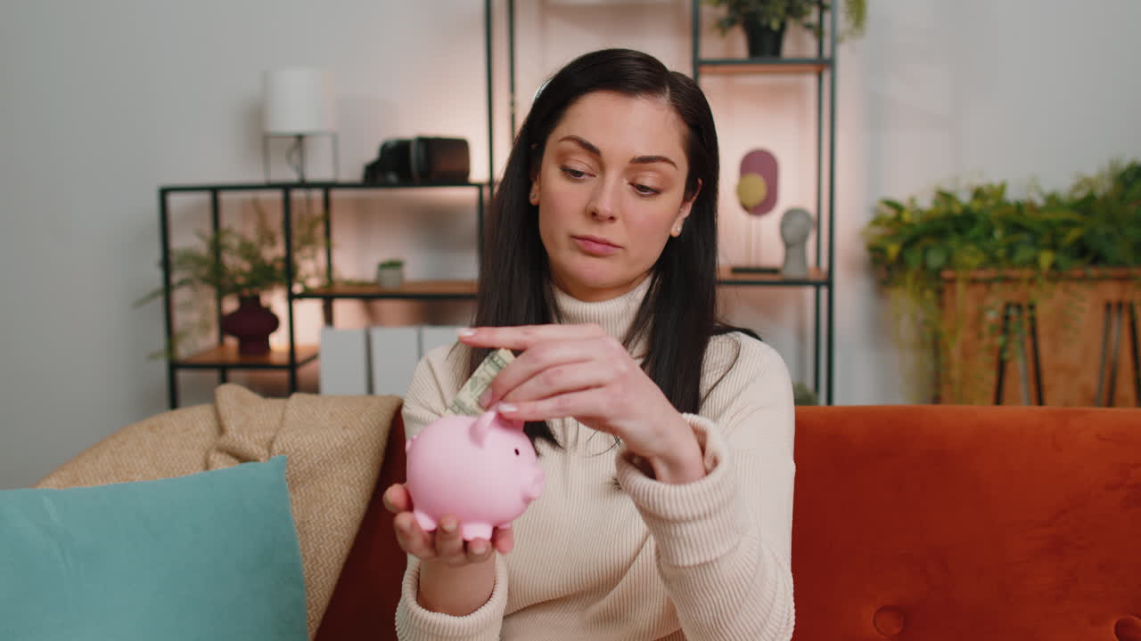Poor brunette woman holding piggybank and one dollar banknote financial crisis bankruptcy poverty