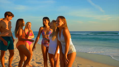 a group of friends having fun on the beach