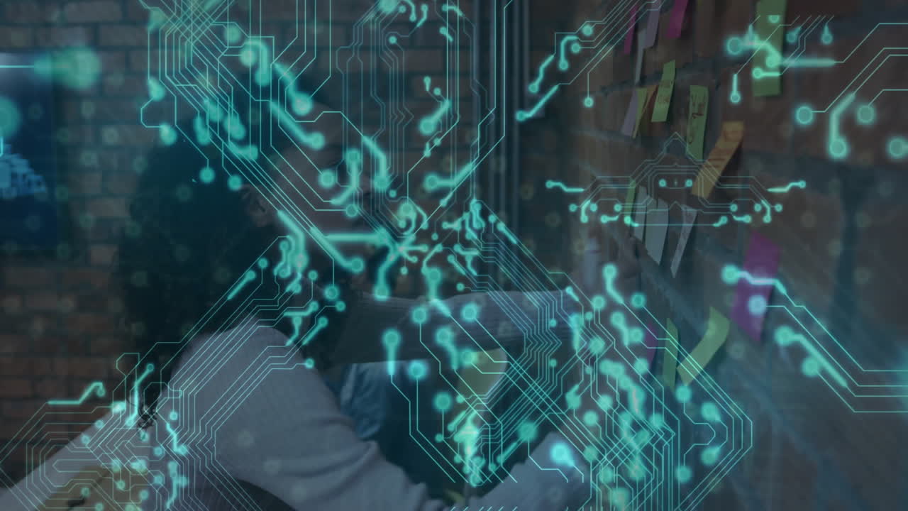 Animation of digital circuit overlaying people working on computers in office