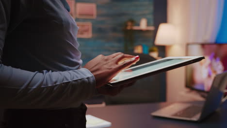 Close-up-photo-of-black-female-hands-holding-tablet-and-typing