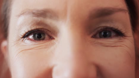 Close-up-of-caucasian-mid-adult-woman's-with-beautiful-eyes-in-yoga-studio