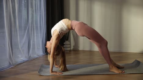 a woman practices yoga in her cozy living room embodying calmness a serene video shows a woman practicing yoga in her cozy living room transitioning through poses and embodying calmness and mindfulness