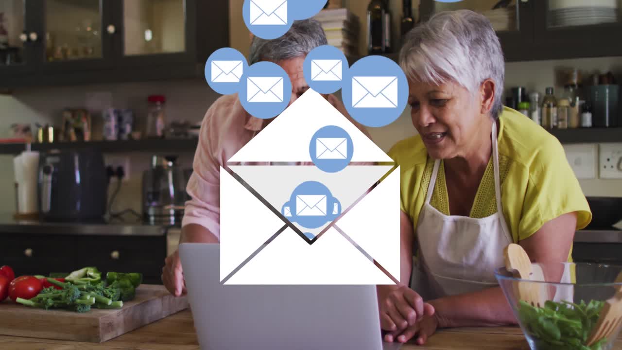 Animation of envelope mail icons over senior couple using laptop at home