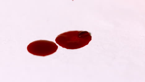 blood dropping on white surface