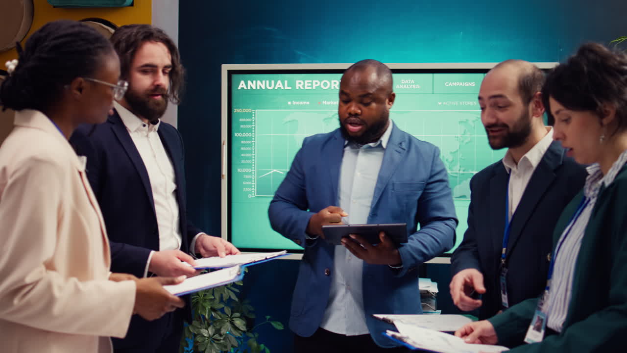 Supervisor and employees attend a status update meeting