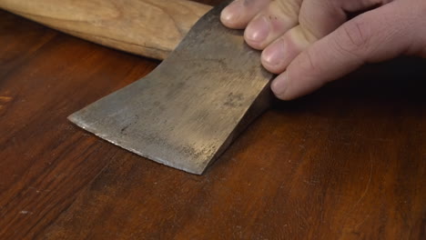 closeup view: corroded axe head is maintained, cleaned with sandpaper