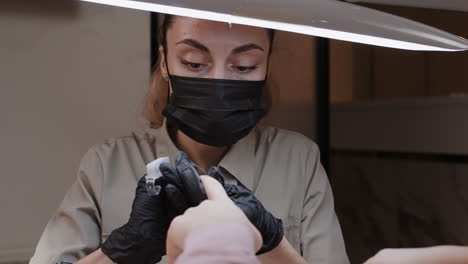 woman receiving a manicure at a nail salon