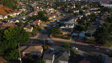 drone follows cars driving through residential street in los angeles california during a fantastic sunset, usa, aerial