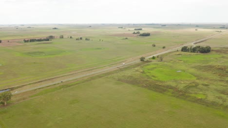 an aerial shot of a road running in the rural neighbourhood