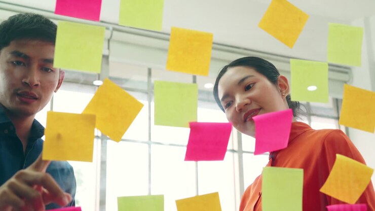 Business people work on project planning board