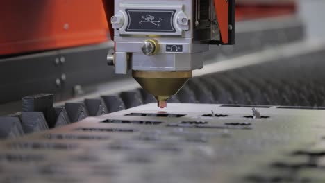 CNC-Laser-cutting-of-metal,-modern-industrial-technology.-Small-depth-of-field.-Warning---authentic-shooting-in-challenging-conditions.
