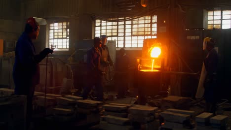 Workers-melting-metal-in-foundry-workshop-4k