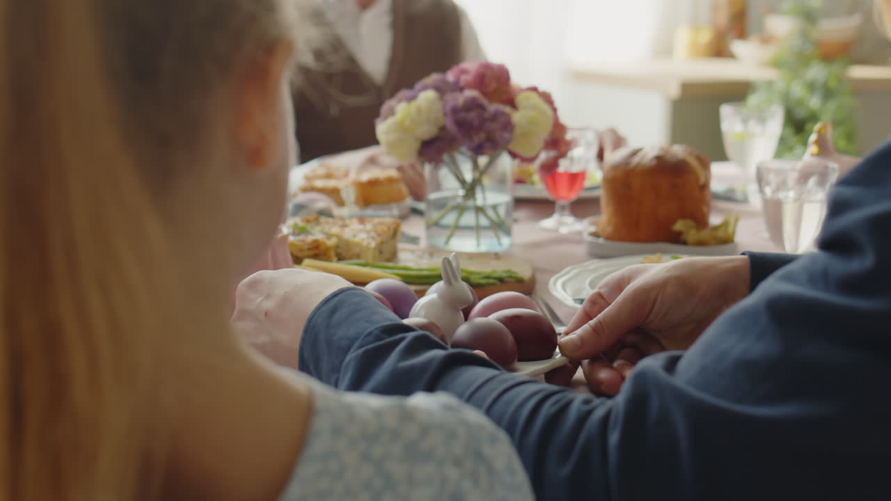Family Sharing Easter Eggs on Festive Dinner