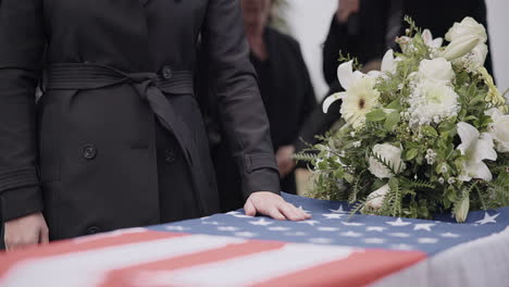 USA-veteran-funeral,-woman-and-casket-with-touch