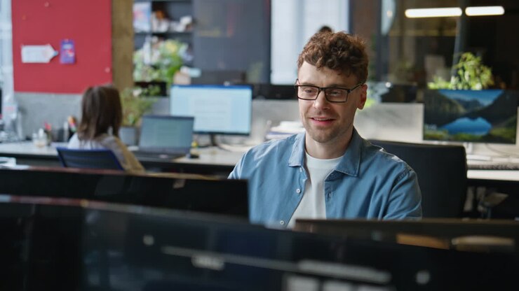 Happy businessman holding mug with hot beverage in corporate office closeup