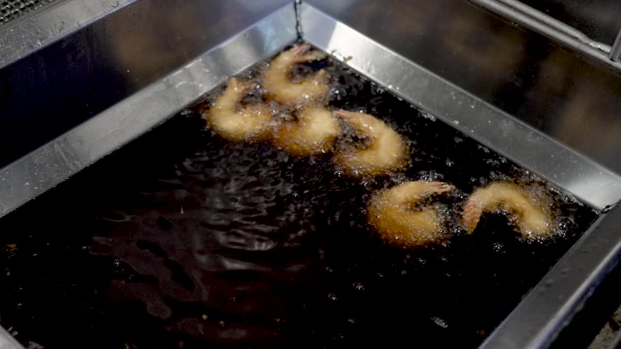 Frying shrimp in a bustling kitchen at sunset, capturing the essence of culinary artistry in every crisp bite