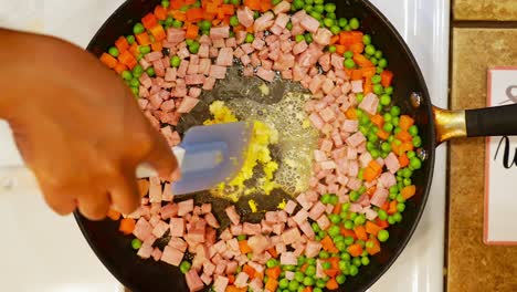 adding minced garlic and broth to the frying