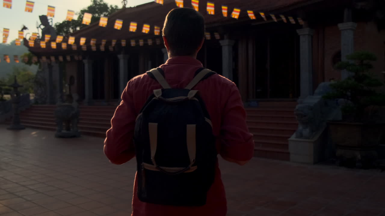 Man with Backpack at a Vietnamese Temple