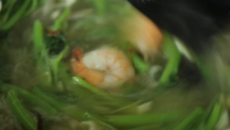 Close-up-of-cooking-spinach-and-prawn-in-a-cooking-pan