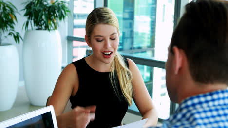 executives interacting with each other at desk