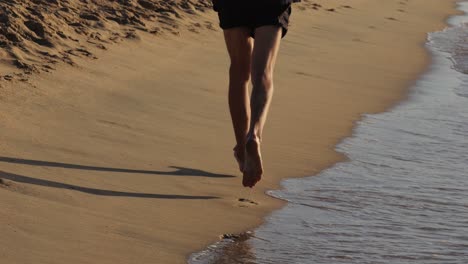 man running on the beach at sunset