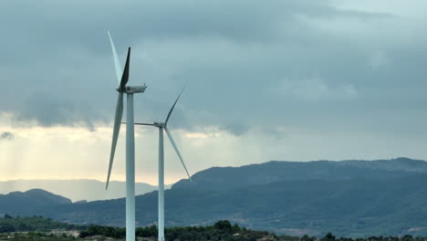 close up view of stopped wind turbine in coll de moro wind mill park on cloudy day at sunset, spain