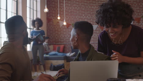 group of business people celebrating corporate success black colleagues laughing clapping cheerful enjoying successful victory watching laptop in modern office workplace