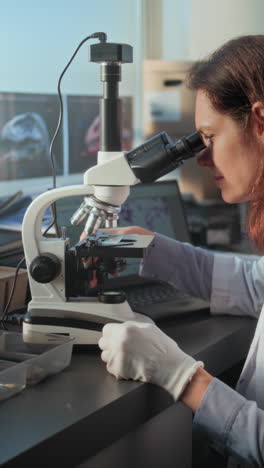 scientist using a microscope in a laboratory