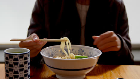 Woman-having-noodles-in-restaurant-4k