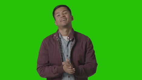 Portrait-Of-Casually-Dressed-Smiling-Young-Man-Against-Green-Screen-2