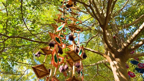 traditional mobile swaying in a tree canopy