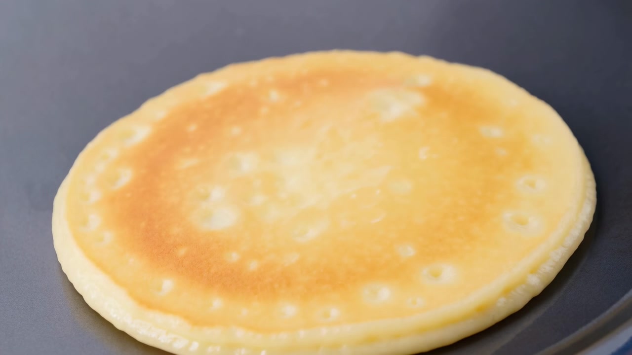 learn to make fluffy pancakes with a step-by-step cooking tutorial on a sunny day, using flour, butter, and sugar in a top-down view on a pan, creating a calm and instructional atmosphere.