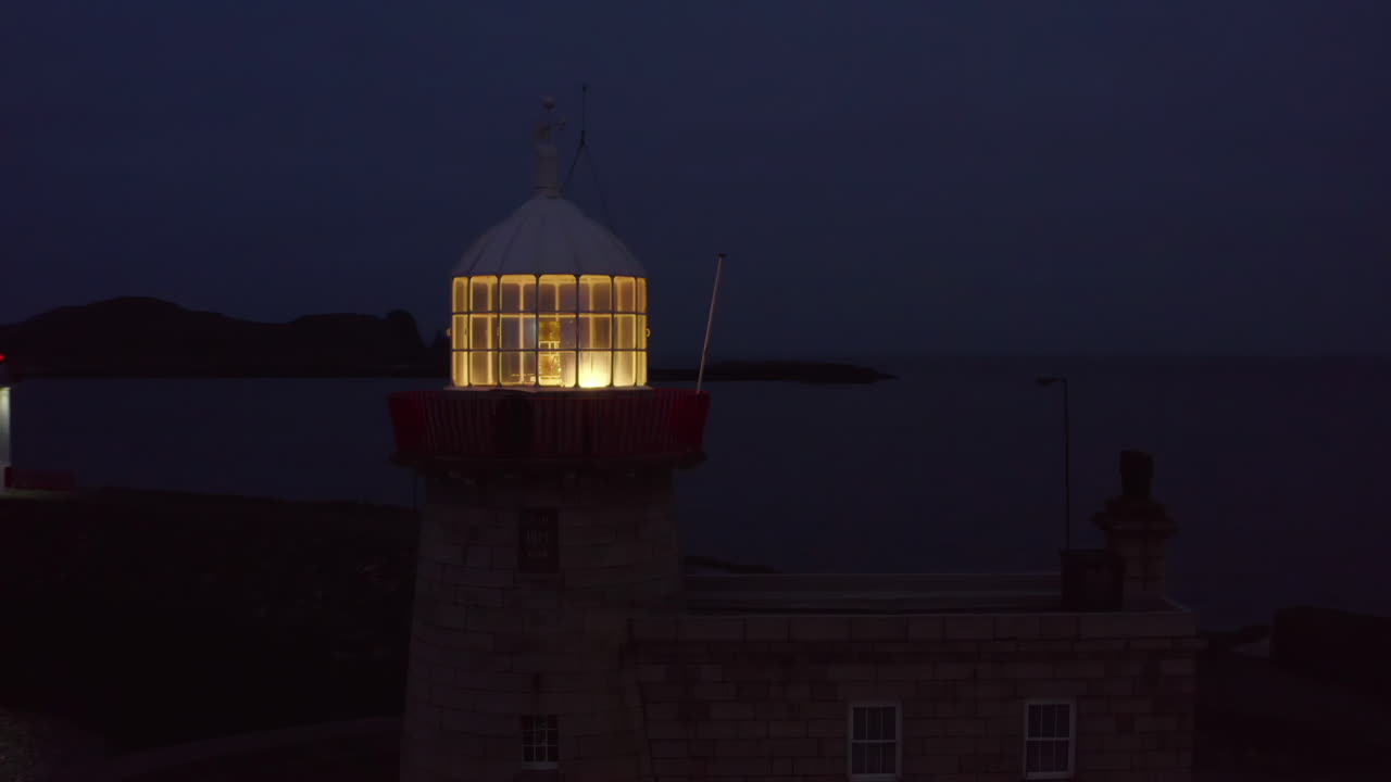 Aerial night shot featuring Howth harbour lighthouse and Ireland's eye